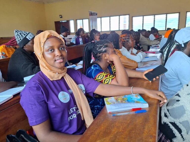 Participants discuss workshop materials at classroom desks.